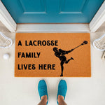 Lacrosse family doormat featuring a player silhouette and the text A Lacrosse Family Lives Here, displayed on a front porch with lacrosse sticks and a ball, making a fun sports welcome mat for any athlete home entrance.