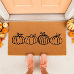 Pumpkin line art doormat for fall porch decor, featuring a natural coir welcome mat with four black pumpkins, perfect for autumn home entryways, seasonal front door rugs, and festive harvest housewarming decorations for your home.