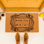 Funny welcome doormat featuring a black decorative frame design and the phrase How You Doin, perfect for a front porch entrance.
