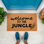Welcome to the Jungle doormat featuring a natural coir fiber texture with bold black text and claw mark graphics, perfect for a fun front porch decor entrance mat or a housewarming gift for plant lovers and jungle themed home