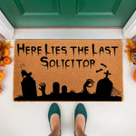Funny Halloween doormat featuring a spooky graveyard scene with tombstones, a cat, and bats, reading Here Lies The Last Solicitor in black text on a natural coir welcome mat for a front porch entryway decor during the fall season.