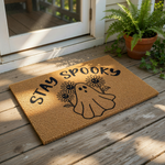 Stay Spooky ghost doormat with sunflowers, a natural coir fiber welcome mat for fall home decor featuring a cute ghost illustration and floral design, perfect for a front porch entrance during the autumn and Halloween holiday