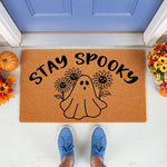 Stay Spooky ghost doormat with sunflowers, a cute fall welcome mat for front porch decor featuring a friendly spirit design on natural coir fiber, perfect for autumn home entrance styling and seasonal outdoor entryway floor mats.