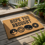 Funny donut doormat with the text Hope You Brought, featuring a natural coir fiber welcome mat design with black printed donuts, perfect for a front porch entry, housewarming gift, or a fun kitchen decor accent for food lovers.