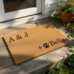 Personalized coir doormat featuring a custom family name and pet paw print design, this durable natural fiber welcome mat is a stylish front porch decor piece for dog lovers and pet owners looking for a custom housewarming entry