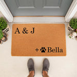 Personalized pet lover doormat featuring a natural coir fiber welcome mat design with custom initials and a paw print icon, perfect for a front porch entryway to celebrate your dog or cat family members in a stylish home decor