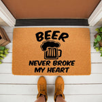 Beer Never Broke My Heart doormat featuring a funny beer mug graphic on natural coir fiber, perfect for a front porch welcome mat or entryway decor for beer lovers who enjoy humorous home accessories and unique outdoor floor mats.