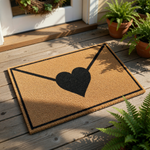 Love letter envelope doormat with a black heart design on natural coir fiber, this outdoor welcome mat features a romantic envelope graphic for a cute front porch entry decor piece that is durable and functional for any home