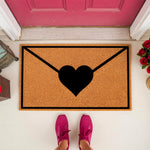 Love letter envelope doormat with a black heart design on natural coir fiber, perfect for a romantic front porch decor.