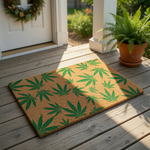 Cannabis leaf print coir doormat featuring a natural brown fiber texture with a repeating pattern of bright green marijuana leaves, perfect as a funny outdoor welcome mat or entryway rug for a home with a relaxed, bohemian style.
