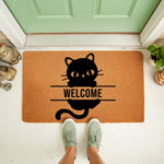 Black cat welcome doormat featuring a cute feline design on natural coir fiber, perfect for a front porch entryway.