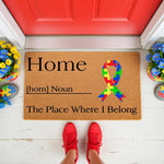 Autism awareness doormat with a colorful puzzle piece ribbon design, featuring the definition of home on a natural coir welcome mat for your front porch, creating a supportive and inclusive entryway decor for your house or