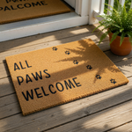 All Paws Welcome coir doormat featuring a natural fiber texture and black paw print design, this pet lover welcome mat is a durable outdoor floor rug for dog owners and cat lovers looking for a cute front porch entry decor piece.