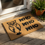 Owl welcome doormat featuring a black graphic of an owl and the text Who Who Who on a natural coir fiber mat, perfect for a funny front porch entrance rug or a unique housewarming decor piece for any bird lover or nature