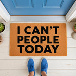 Funny I Can't People Today doormat featuring bold black text on a natural coir fiber welcome mat, placed on a white porch in front of a blue door, perfect for a sarcastic home decor entrance or a humorous housewarming front door