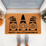 Happy Hallothanksmas gnome doormat featuring three cute gnomes with a pumpkin, leaf, and gift, perfect for fall, Halloween, and Christmas porch decor, this natural coir welcome mat adds seasonal charm to any front door entryway.