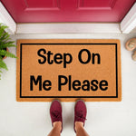 Funny Step On Me Please doormat made of natural coir fiber, featuring a bold black border and text, displayed as a front porch welcome mat for home entryways to provide a humorous and inviting entrance for guests and visitors.