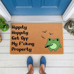 Funny frog doormat with a rude saying and a cute frog holding a knife, perfect for a front porch welcome mat.