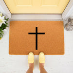 Religious cross doormat featuring a simple black cross design on a natural fiber coir welcome mat, placed on a front porch with a yellow door, providing a stylish and welcoming entrance for your home decor and outdoor floor