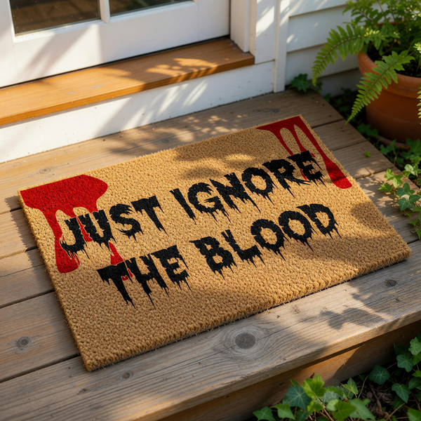 Funny Halloween doormat with Just Ignore The Blood text and red splatter design, this spooky coir welcome mat is a perfect horror movie front porch decor piece for a scary home entrance or a creepy housewarming gift for horror