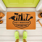 Dad's Workshop doormat featuring tool graphics and the text Toys Fixed Free, this personalized welcome mat for a garage or porch is a fun home decor item for a handyman, father, or husband who loves DIY home improvement projects.