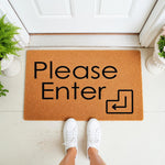 Please Enter doormat with a modern arrow icon, featuring a natural coir fiber welcome mat placed at a front door entrance, perfect for home decor, porch styling, and housewarming entryways with a clean, minimalist typography