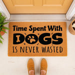 Dog lover welcome doormat featuring the quote Time Spent With Dogs Is Never Wasted, this natural coir fiber entry rug is a funny pet owner home decor piece for a front porch, entryway, or mudroom floor with a cute paw print