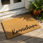 Konnichiwa coir doormat featuring a natural fiber texture and black script lettering, this durable outdoor welcome mat is a stylish entryway rug for your front porch or home entrance to greet guests with a friendly Japanese