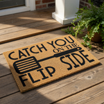 Funny kitchen doormat with spatula graphic and text reading Catch You On The Flip Side, a natural coir fiber welcome mat for home entryways, front porch decor, or a housewarming present for cooking enthusiasts and food lovers.