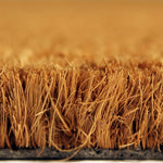 A close-up view of a textured surface, possibly a woven material or a natural plant fiber, with a warm, golden-brown color.