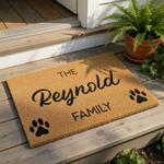 Personalized family name doormat with paw prints, featuring a natural coir fiber welcome mat design for pet lovers, custom last name floor rug for front porch entry, durable outdoor entrance mat for dog or cat owners home decor.