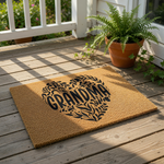 Grandma coir doormat featuring a black heart design made of leaves and vines, this natural fiber welcome mat is a stylish front porch decor piece for a home entrance, perfect for a housewarming or family celebration.