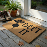 Beet It funny vegetable doormat featuring a black graphic of a garden beet on a natural coir fiber background, providing a humorous welcome for your front porch or entryway with its clever pun and rustic, durable outdoor mat