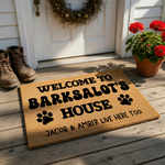 Personalized Dog Welcome Doormat featuring a natural coir texture with bold black text that reads Welcome to Barksalot's House, accented by two paw prints and a playful note about the humans who live there too on a clean white
