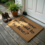 Funny Welcome Doormat with the text You sure you want to be here? printed in a bold black script font on a natural tan coir fiber mat, creating a humorous and sarcastic entryway decor piece for your front porch or home entrance.