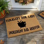 Finally Our Last Ingredient Has Arrived doormat featuring a black cauldron graphic on a natural coir fiber background, perfect for a fun and spooky home entrance that welcomes guests with a touch of magical humor and personality.