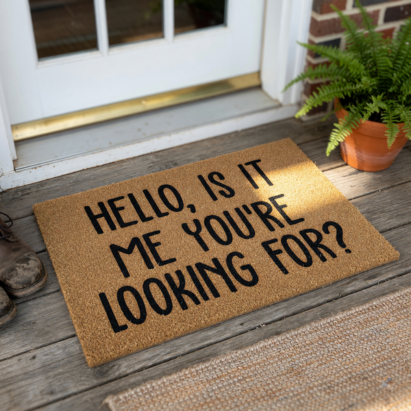 Funny Hello Is It Me You Are Looking For doormat featuring bold black text printed on a natural brown coir fiber mat, creating a humorous and welcoming entrance piece for your front porch or home entryway on a clean white