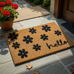 Floral Hello Coir Doormat featuring a natural brown coconut fiber texture decorated with black printed flower silhouettes and the word hello in a modern script font, creating a welcoming entryway accent for your front porch decor.