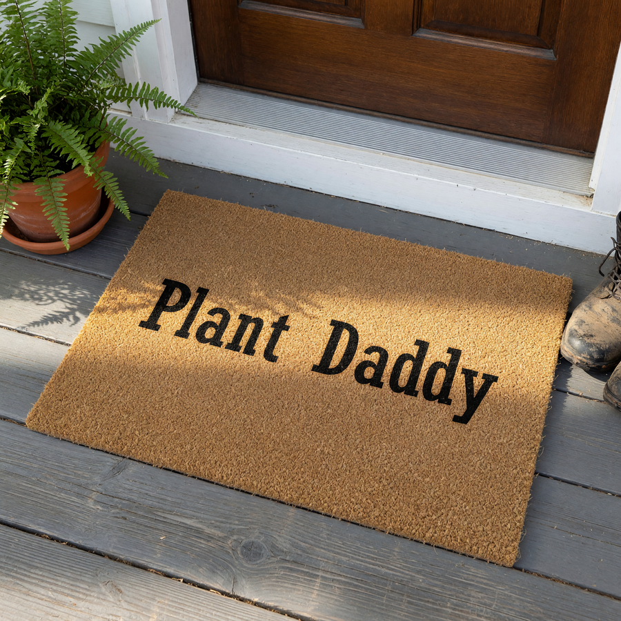 Plant Daddy coir doormat featuring a natural brown fiber texture and bold black lettering, centered on a plain white background to showcase the humorous design for any indoor or outdoor entryway or front porch decor.