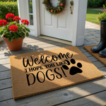 Dog lover welcome doormat made of natural coir fiber featuring the black printed text Welcome I Hope You Like Dogs and a large paw print graphic, set against a clean white background for a modern and humorous entryway decor style.