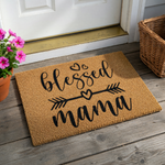 Blessed Mama coir doormat featuring a natural brown fiber texture with black script text, decorative hearts, and an arrow design, providing a welcoming and stylish accent for a front porch or entryway floor decor.