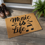 Music is Life coir doormat featuring black script text and musical notes on a natural fiber welcome mat, displayed on a rustic white wood background for a stylish entryway decor look that music lovers will truly enjoy.