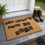 She Doesn't Even Go Here coir doormat featuring a funny movie quote printed in a ransom note style with black letters on a natural brown coconut fiber background, perfect for a pop culture themed front porch entryway decor.