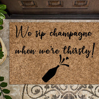 We sip Champagne when we're thirsty Funny Doormat